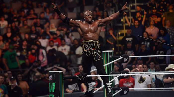 Jul 18, 2021; Fort Worth, TX, USA;Bobby Lashley (black trunks) with MVP (suit) battles Kofi Kingston (purple pants) for the WWE World Heavyweight Championship during Money in the Bank at Dickies Arena.